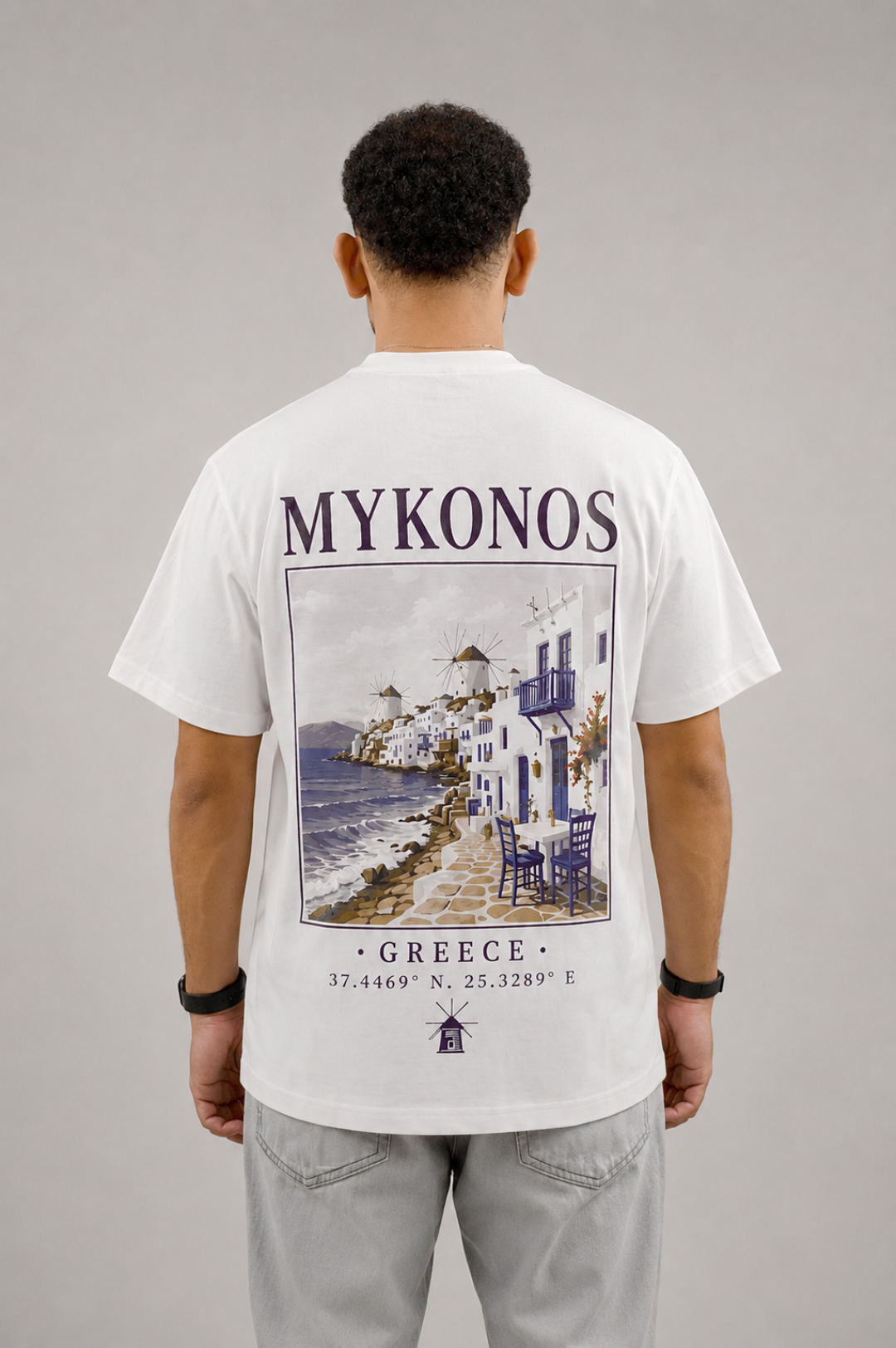 White AUREO Mykonos oversized tee, back view, the city of Mykonos
